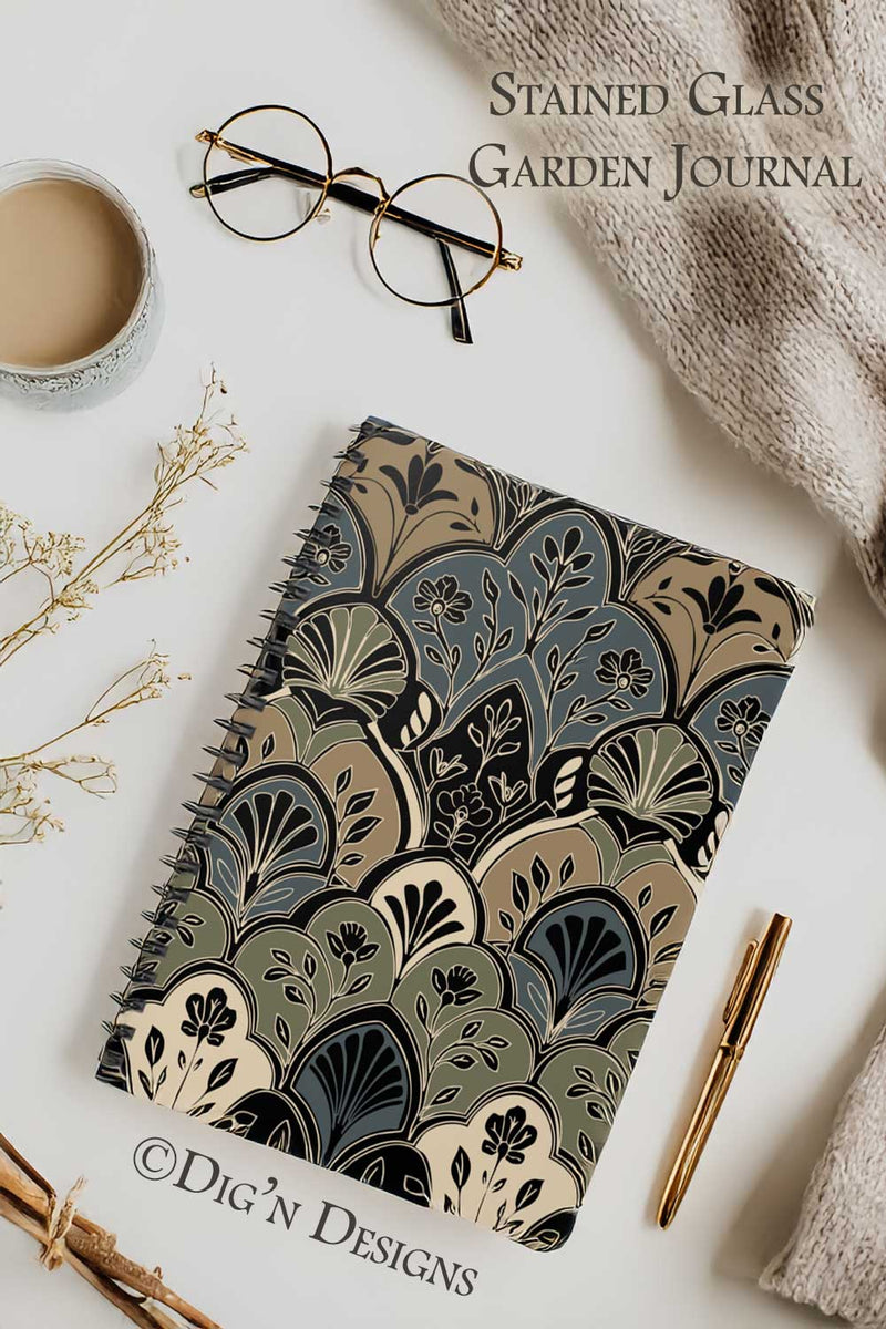 Stained glass patterned journal with a cup of coffee, glasses, and a pen on a light background