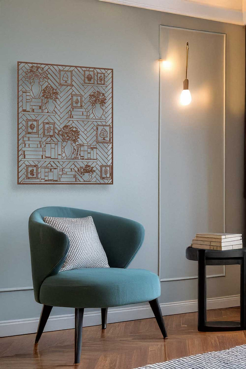 Teal chair with a patterned pillow in a room with a geometric wall art piece and a mirror.