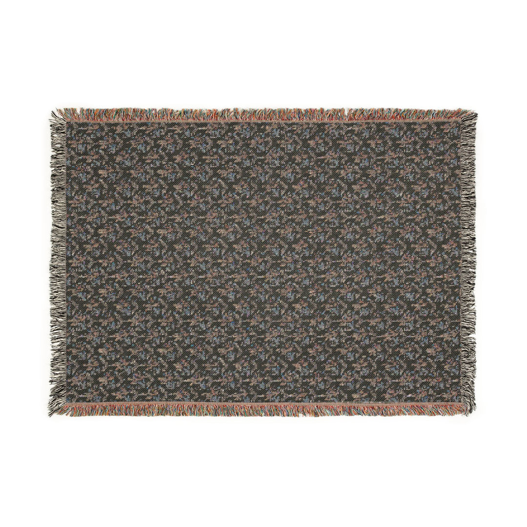 Textured throw blanket with fringes on a white background