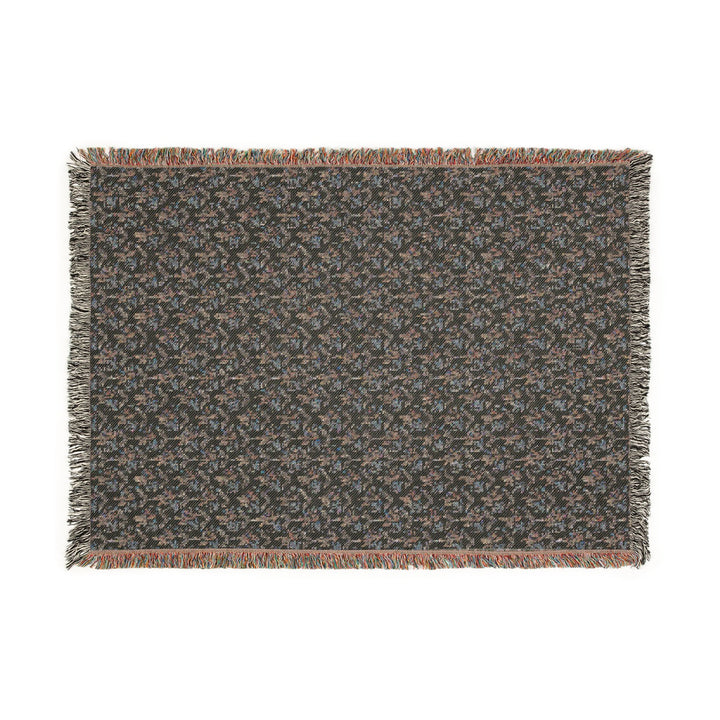 Textured throw blanket with fringes on a white background