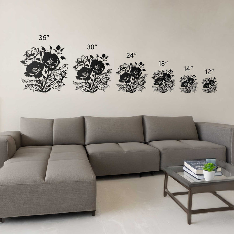 Wall decal set with floral designs and measurements above a gray sectional sofa.