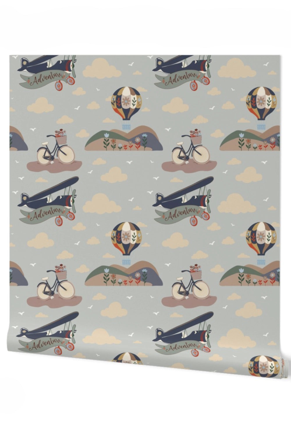A roll of wallpaper featuring a whimsical vintage pattern with biplanes, hot air balloons, bicycles, clouds, and small illustrated figures on a light gray background.