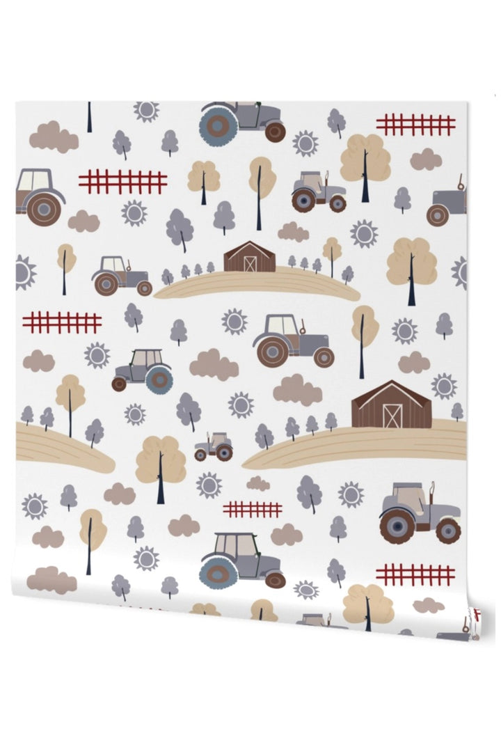 A roll of wallpaper with a repeating farm-themed pattern featuring tractors, barns, fences, trees, and suns on a white background.