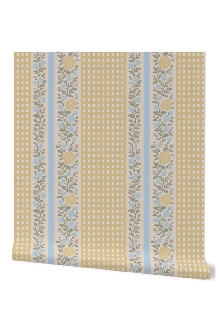 A roll of wallpaper featuring vertical stripes with a beige gingham pattern, light blue stripes, and floral motifs in yellow and green.