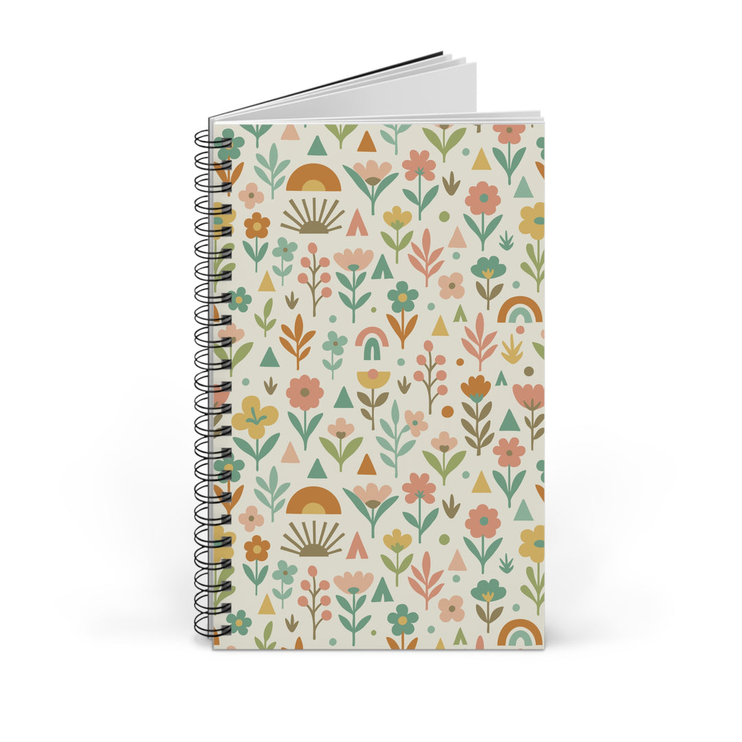 A spiral-bound notebook with a cream-colored cover decorated with a colorful retro boho floral pattern, shown on a clean white background.
