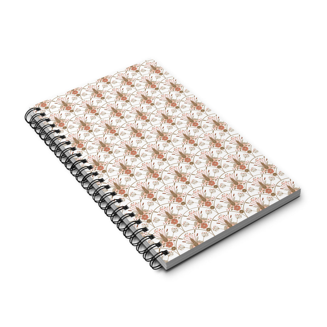 A spiral-bound notebook with a white cover decorated in a repeating pattern of orange and brown butterflies, shown on a clean white background.