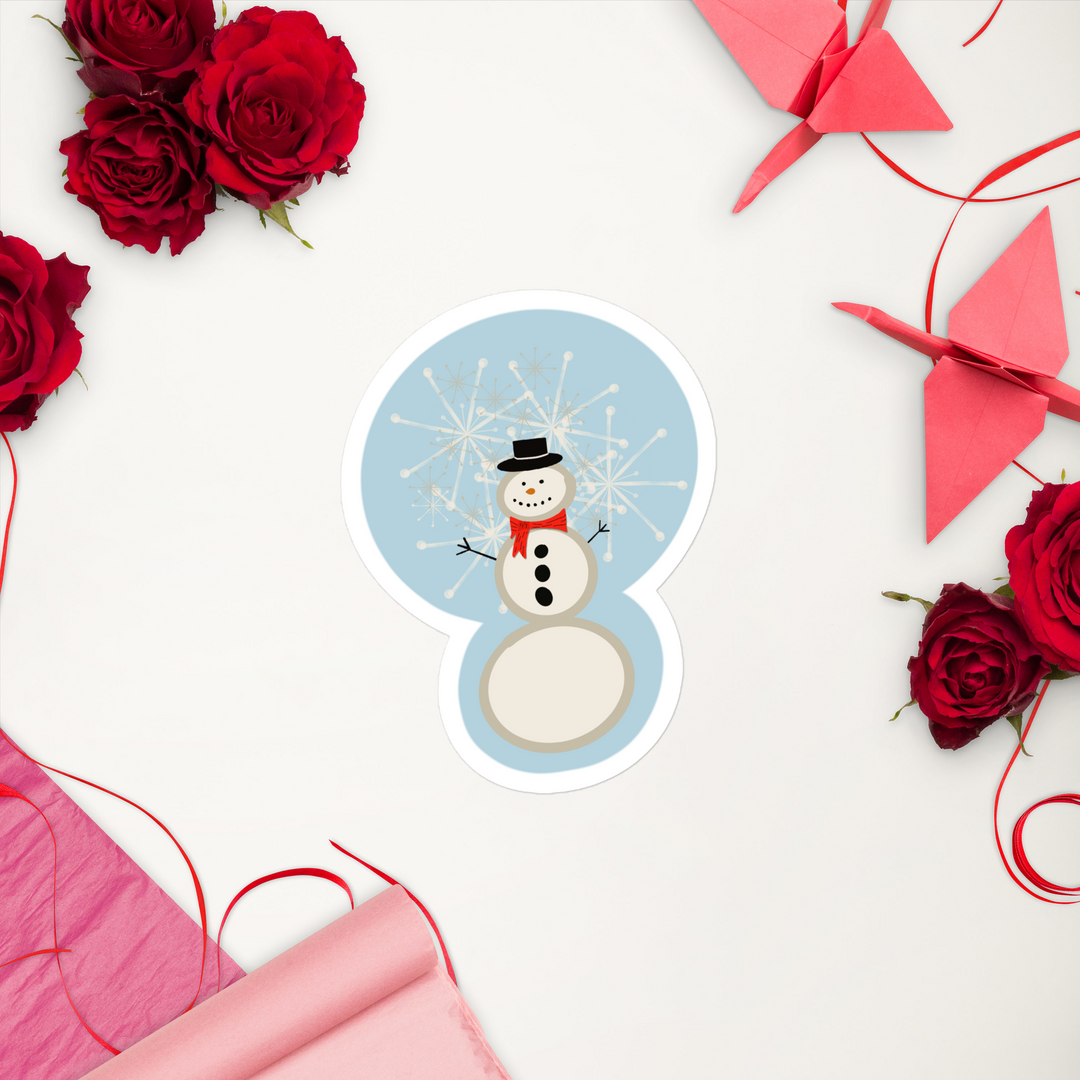 display of a snowman sticker that shows him in a red scarf and button down coal on his chest.  Snowflakes are also falling behind him.