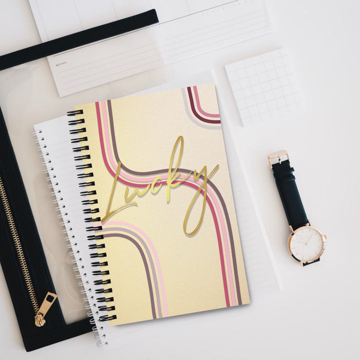 Lucky golden notebook product display sitting on other notebooks