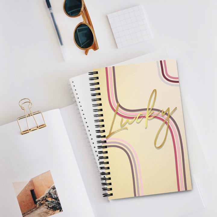 Lucky golden notebook product display sitting on other notebooks
