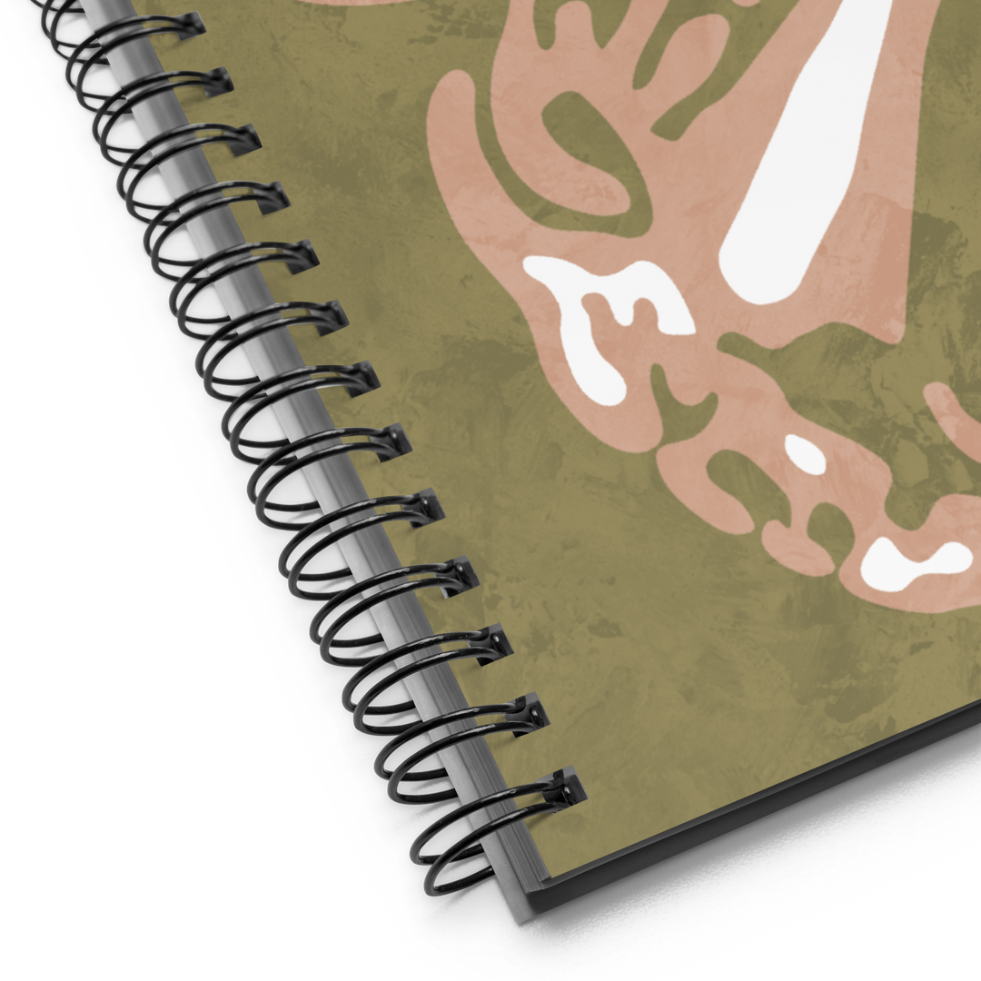 Picture of a green notebook with half of a coral colored butterfly with detailed wings.