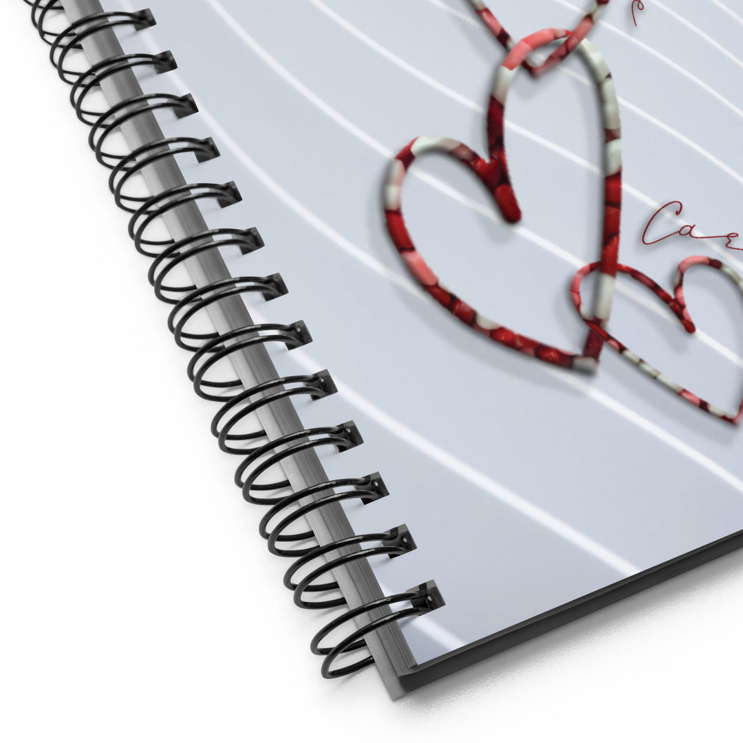 Chain link hearts with words around the design as the pattern on a notebook