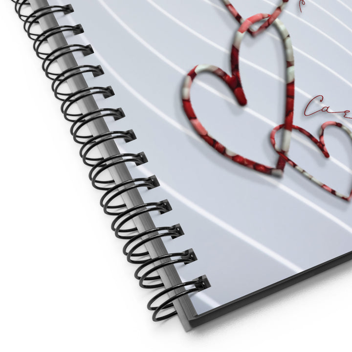 Chain link hearts with words around the design as the pattern on a notebook
