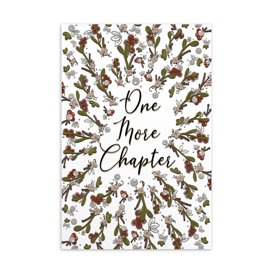 A bookmark with the words "one more chapter" written on it with flowers surrounding it 