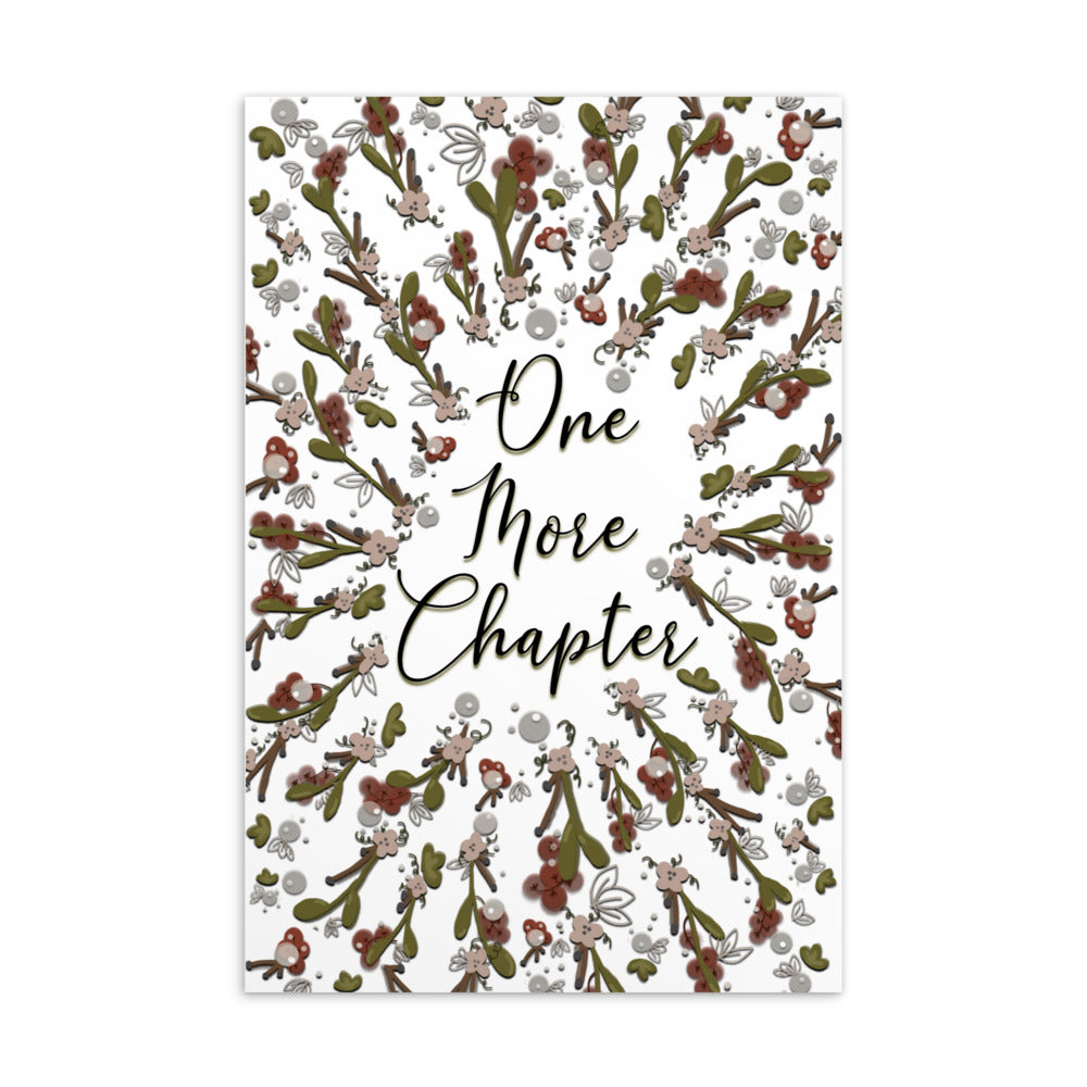 A bookmark with the words "one more chapter" written on it with flowers surrounding it 