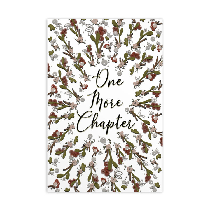 A bookmark with the words "one more chapter" written on it with flowers surrounding it 