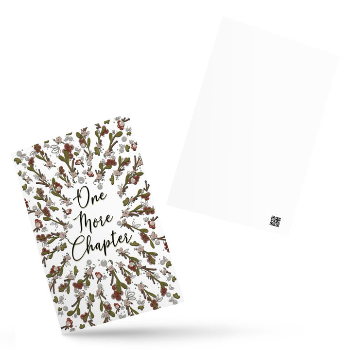 A bookmark with the words "one more chapter" written on it with flowers surrounding it 
