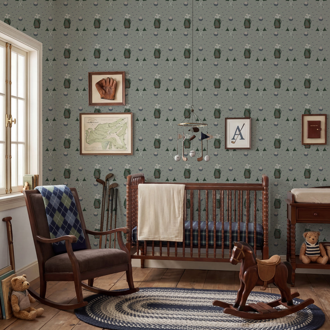 A styled nursery interior featuring a crib, rocking chair, rug, and wall covered in a repeating owl-patterned wallpaper. The room includes framed wall art, a hanging mobile, a rocking horse, and toys, with natural light coming from a window on the left.