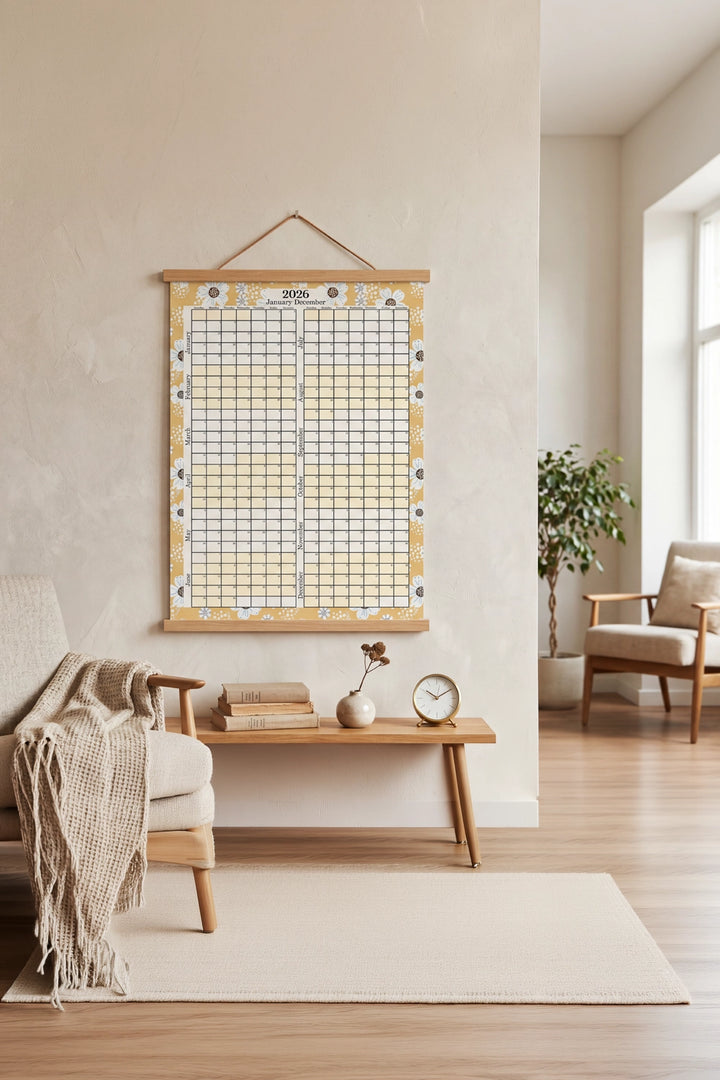 Room interior with a decorative grid wall hanging, wooden desk, and armchair.