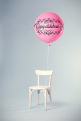 Product display of the words Congratulations as a cut out for cutting machines.  This product display shows the words congratulations displayed on a helium balloon that is floating above a chair.  Great display idea for anyone that you are trying to make feel special on that very special occassion.