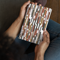 Picture of someone holding the earth tone, neutral striped spiral notebook.  Showing how nice it looks and also the size of the notebook